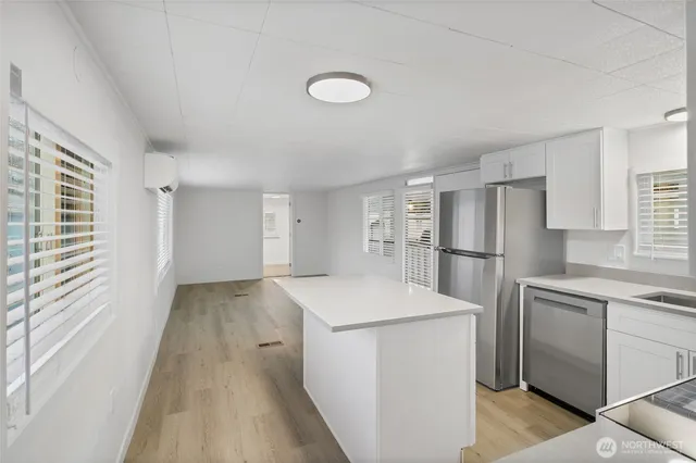 a kitchen with a refrigerator sink stove and cabinets