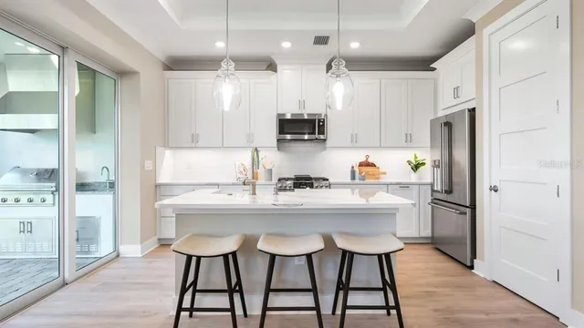 a kitchen with stainless steel appliances a sink a stove and a refrigerator