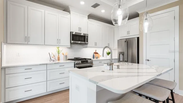 a kitchen with a refrigerator stove and sink