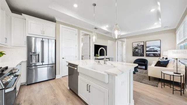 a bedroom with a bed a mirror and a large window