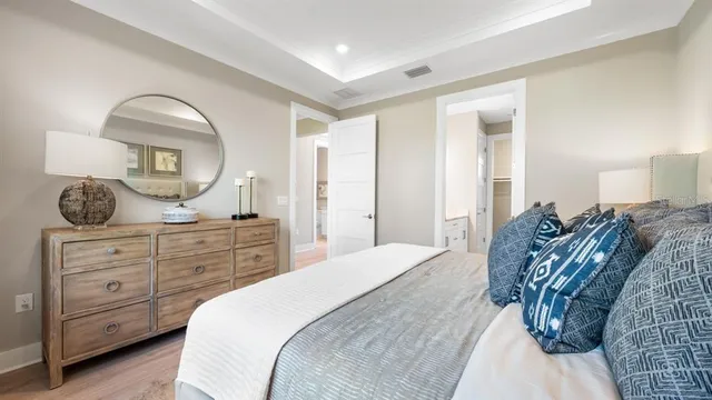 a bed room with a bed and a painting on the wall