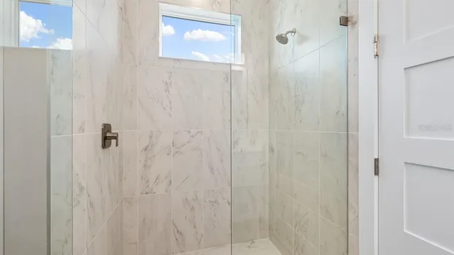 a bathroom with a bathtub a sink a vanity a sink and a mirror