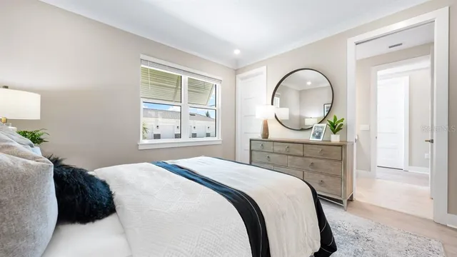 a kitchen with stainless steel appliances granite countertop a stove top oven a sink a refrigerator and white cabinets