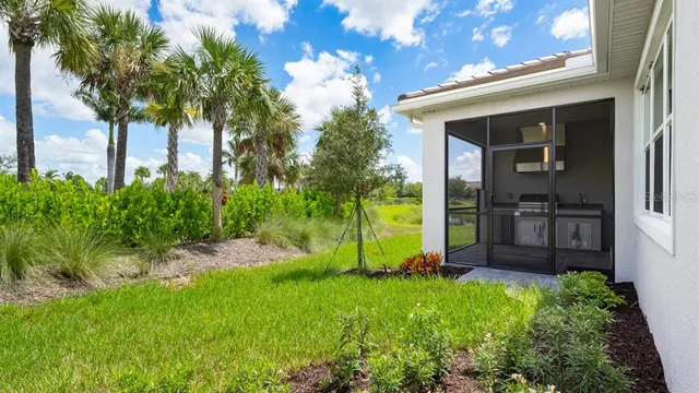 an aerial view of a residential houses with yard