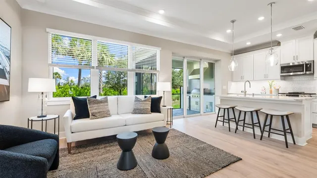 a kitchen with stainless steel appliances a sink a stove a refrigerator cabinets and a counter space