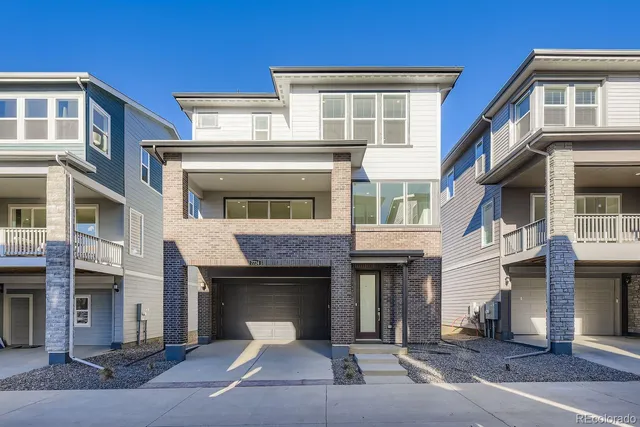 a front view of a brick house with many windows