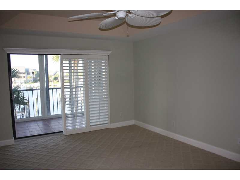 1901 Bay Road, Unit 203 Vero Beach, FL 32963 - Photo 17 of 22 a view of an empty room with wooden floor and a window
