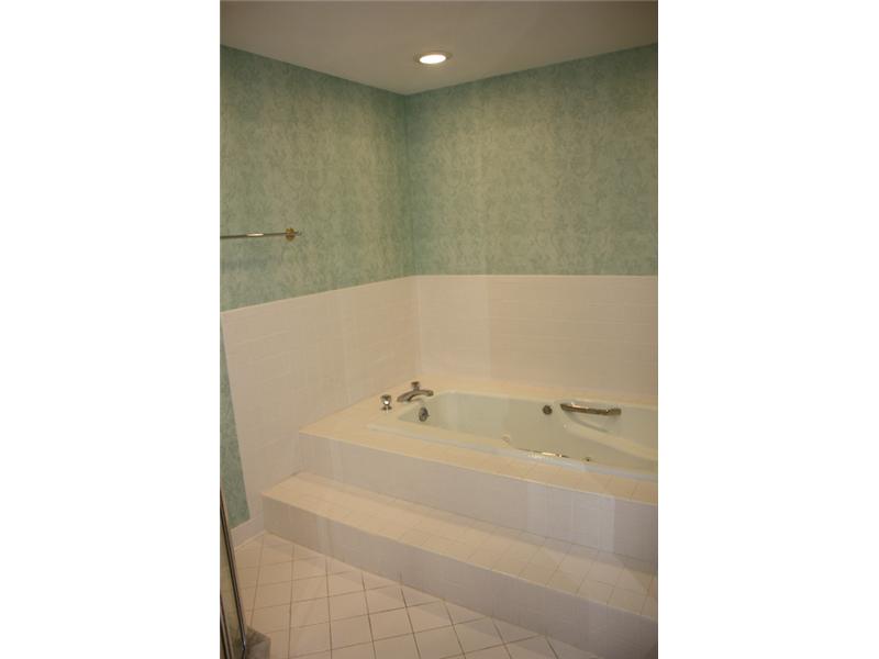 1901 Bay Road, Unit 203 Vero Beach, FL 32963 - Photo 20 of 22 a bathroom with a bathtub and a shower