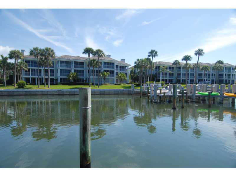 1901 Bay Road, Unit 203 Vero Beach, FL 32963 - Photo 2 of 22 a view of a lake with a house in the background