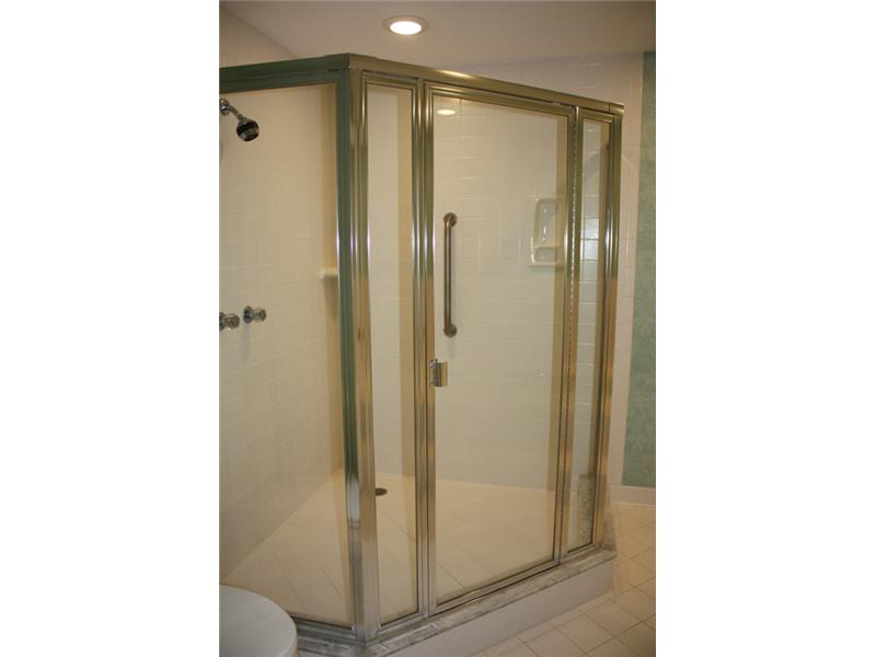 1901 Bay Road, Unit 203 Vero Beach, FL 32963 - Photo 21 of 22 a bathroom with a glass shower door