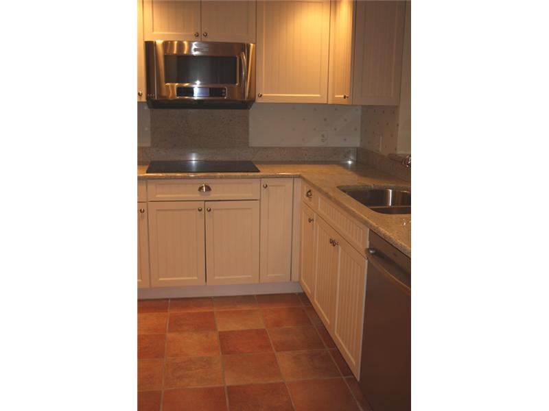 1901 Bay Road, Unit 203 Vero Beach, FL 32963 - Photo 8 of 22 a view of a kitchen with storage and utility