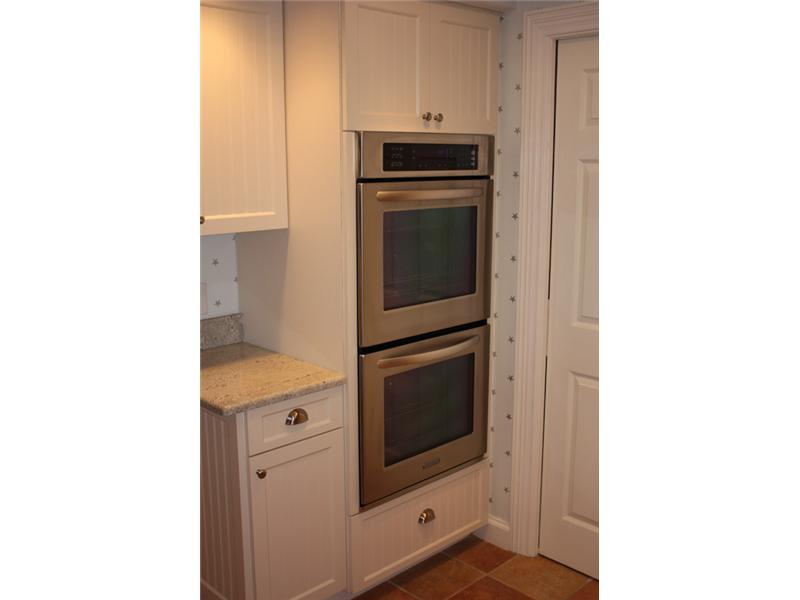 1901 Bay Road, Unit 203 Vero Beach, FL 32963 - Photo 9 of 22 a kitchen with a stove and a microwave