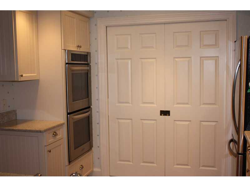 1901 Bay Road, Unit 203 Vero Beach, FL 32963 - Photo 10 of 22 a kitchen with cabinets and stainless steel appliances