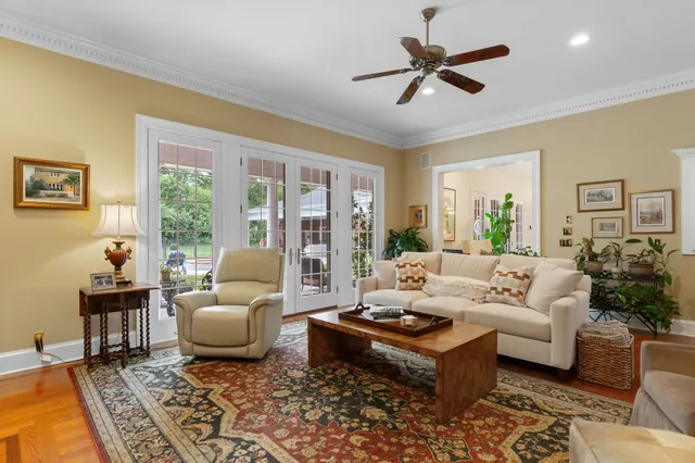 a dining room with furniture potted plants and wooden floor