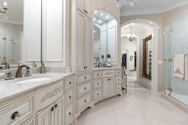 a spacious bedroom with a bed and a chandelier