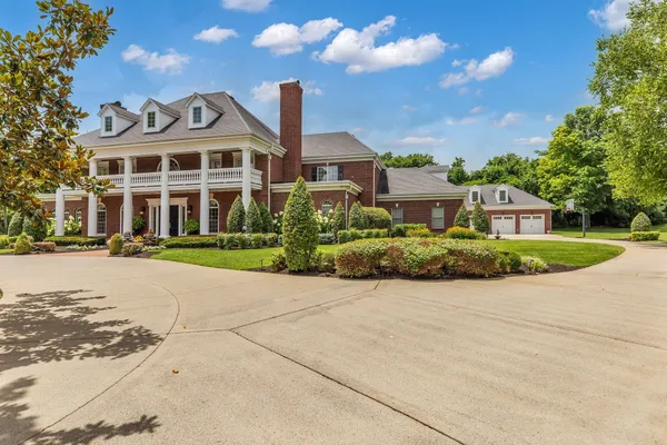 a front view of a building with garden