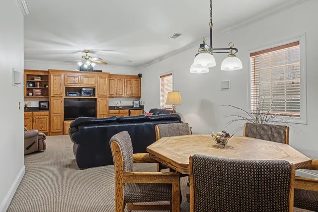 a bedroom with furniture and a ceiling fan