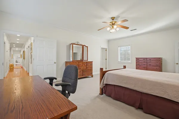 a front view of a house with a chairs and table in a patio