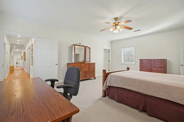 a front view of a house with a chairs and table in a patio