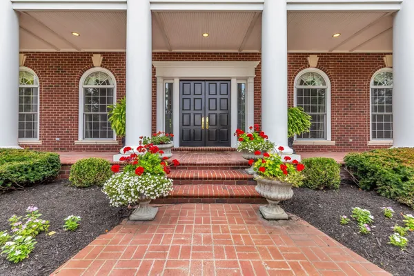 a living room with furniture a piano and a table