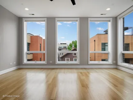 a view of wooden floor and windows in a room