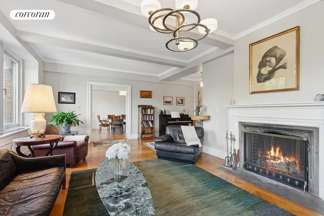 a living room with furniture a fireplace and a large window