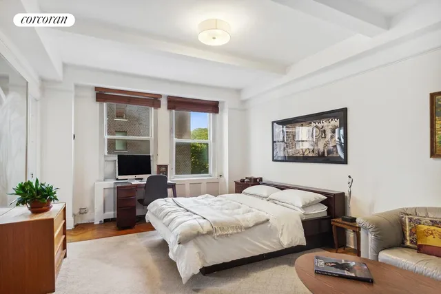 a bedroom with a bed and a couch