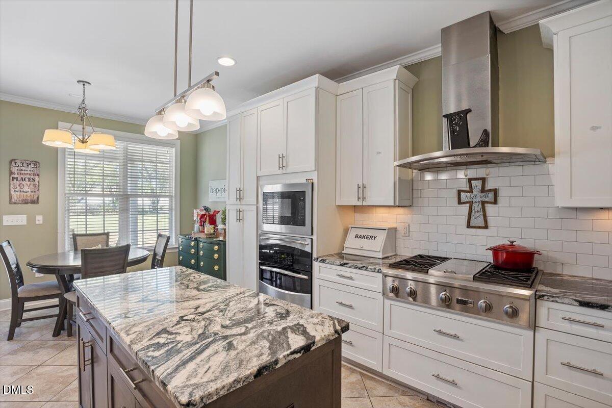 1001 Bellewood Farms Road Raleigh, NC 27603 - Photo 20 of 39 a kitchen with stainless steel appliances granite countertop a stove a sink and a refrigerator