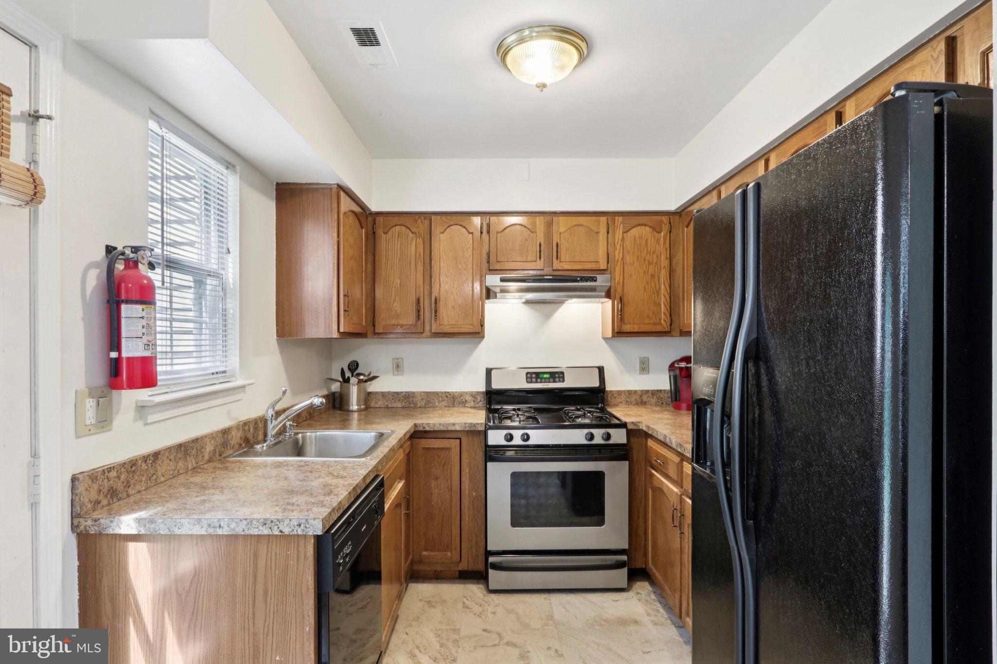 329 Gwynedd Court Mount Laurel, NJ 08054 - Photo 19 of 52 a kitchen with granite countertop a sink stove and refrigerator