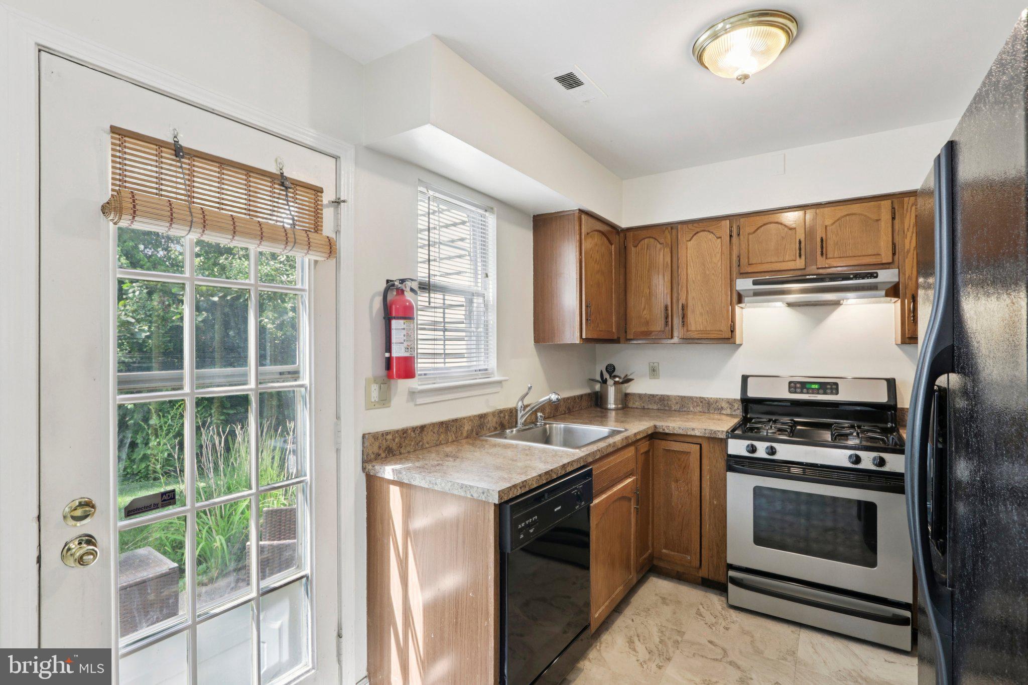329 Gwynedd Court Mount Laurel, NJ 08054 - Photo 21 of 52 a kitchen with granite countertop a stove a sink and a refrigerator