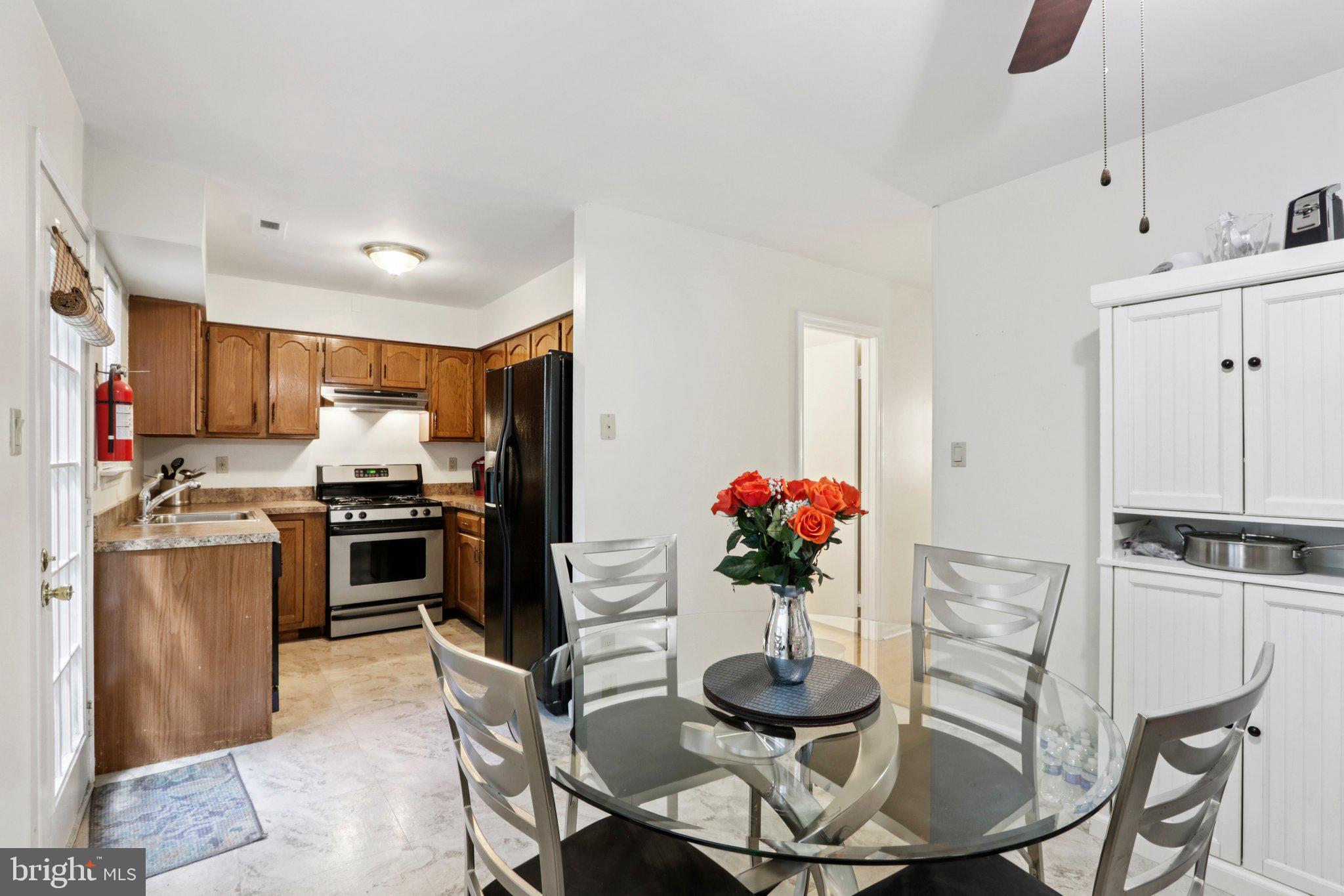 329 Gwynedd Court Mount Laurel, NJ 08054 - Photo 24 of 52 a kitchen with stainless steel appliances kitchen island granite countertop a dining table and chairs