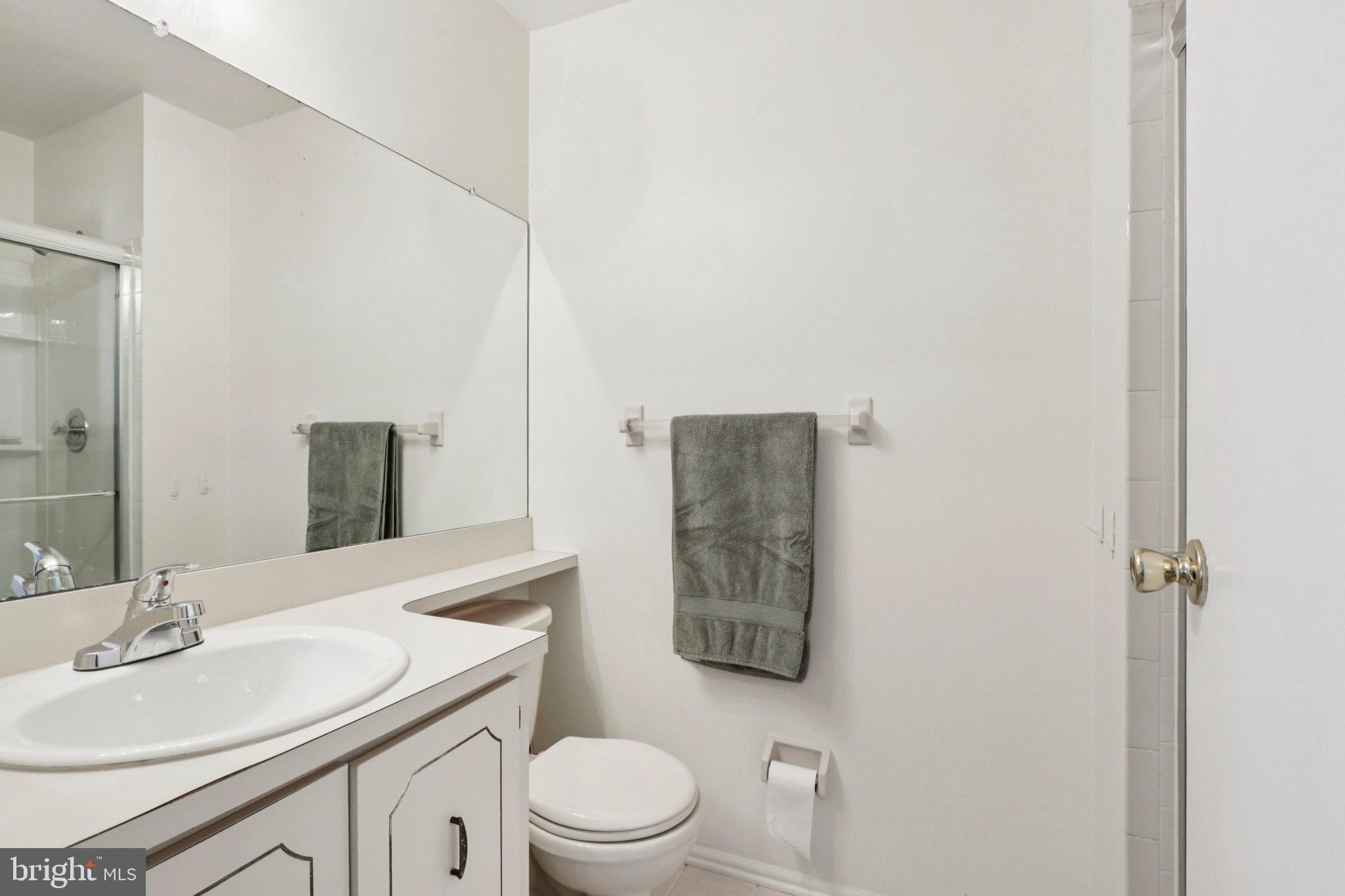 329 Gwynedd Court Mount Laurel, NJ 08054 - Photo 31 of 52 a bathroom with a toilet sink vanity and mirror