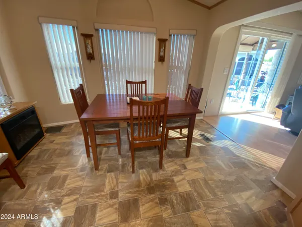 a view of a dining room with furniture and a window