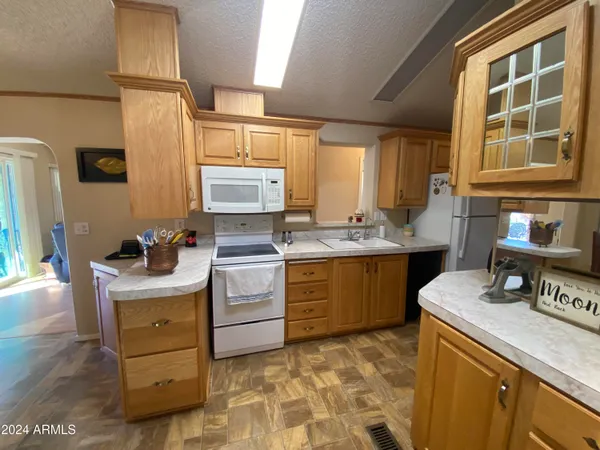 a kitchen with a stove a sink and a refrigerator