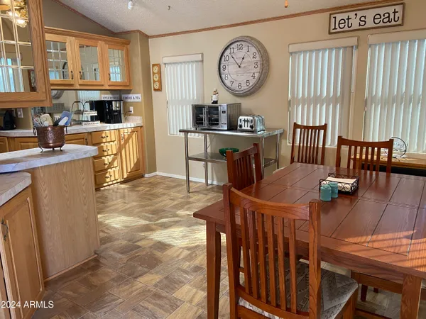 a living room with furniture a large window and wooden floor