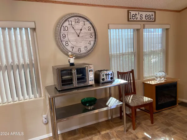 a living room with furniture a window and a large mirror