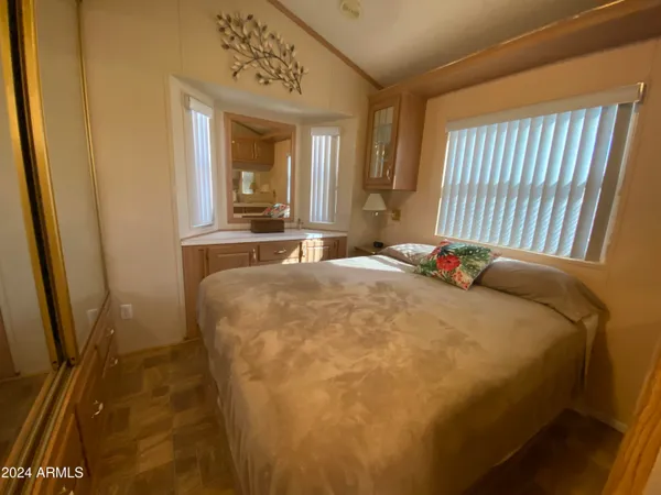 a bed sitting in a bedroom next to a window