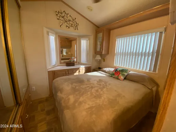 a bed sitting in a bedroom next to a window