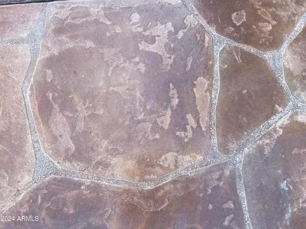 a view of dinning table and chairs in the patio in front of building