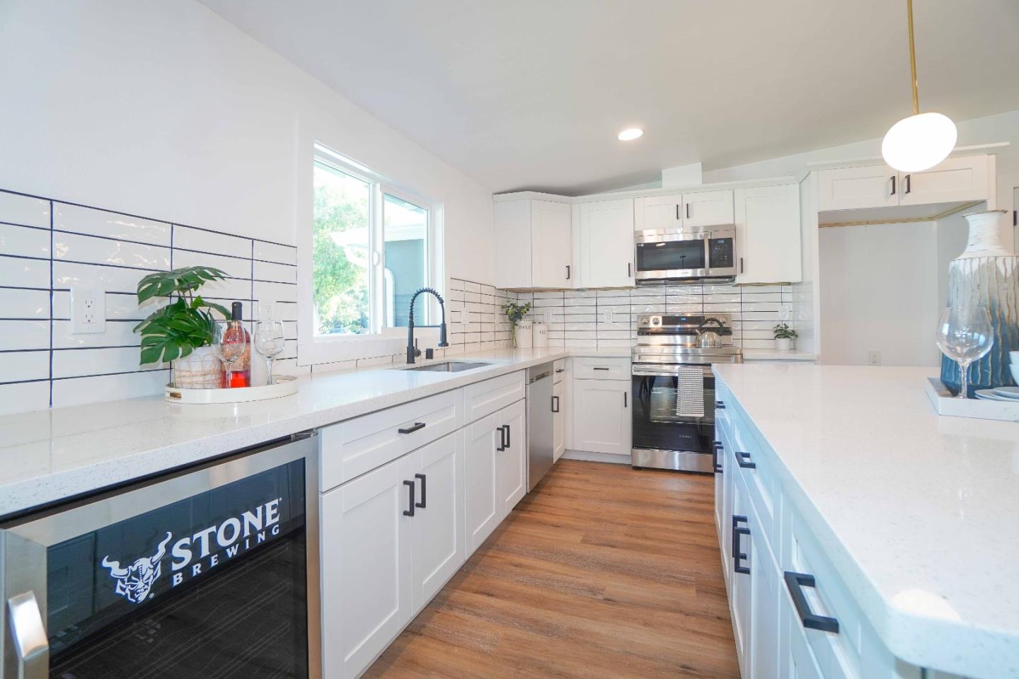 75 Lawton Drive Milpitas, CA 95035 - Photo 12 of 32 a kitchen with kitchen island granite countertop lots of counter top space and stainless steel appliances