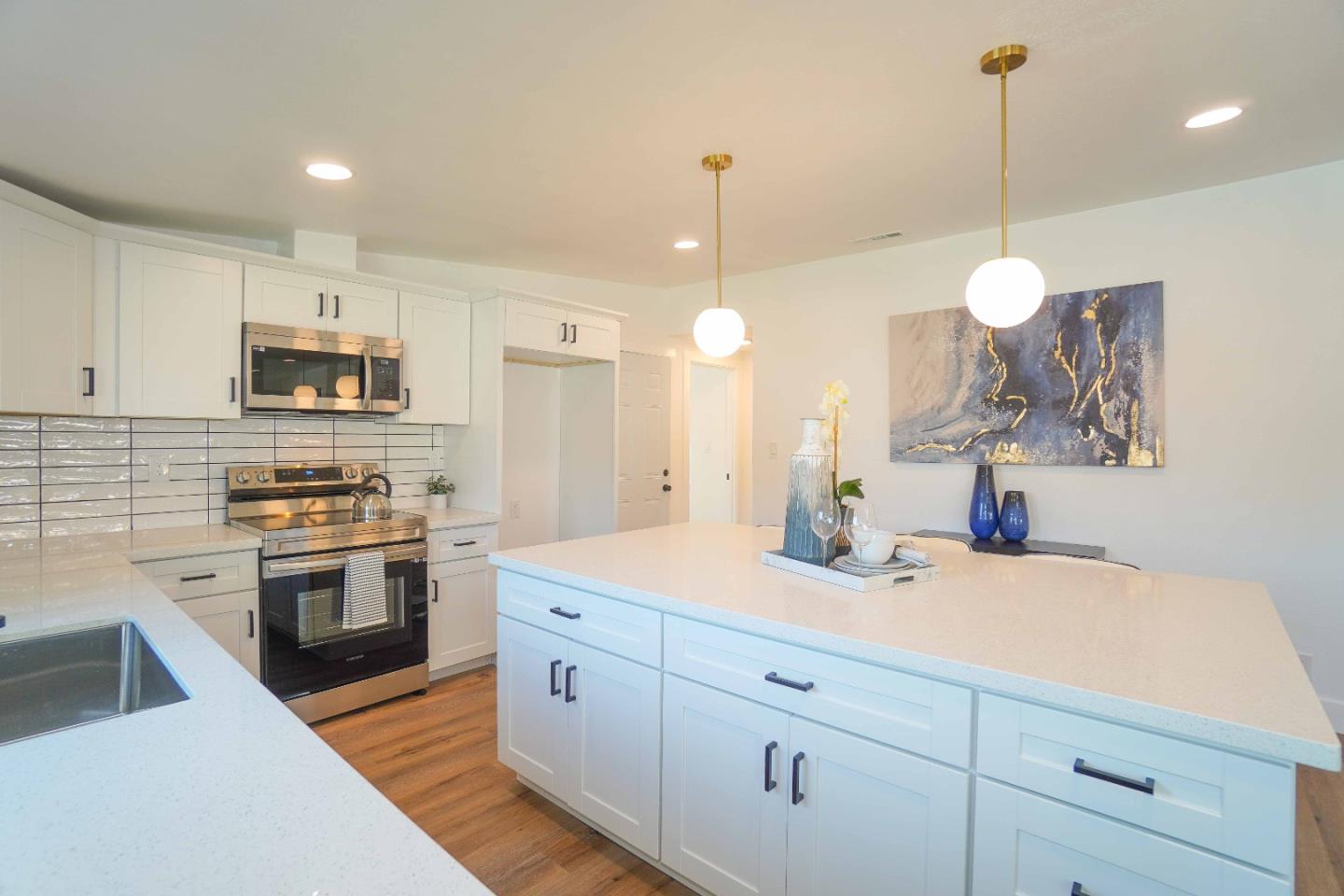 75 Lawton Drive Milpitas, CA 95035 - Photo 13 of 32 a kitchen with a sink and stove top oven