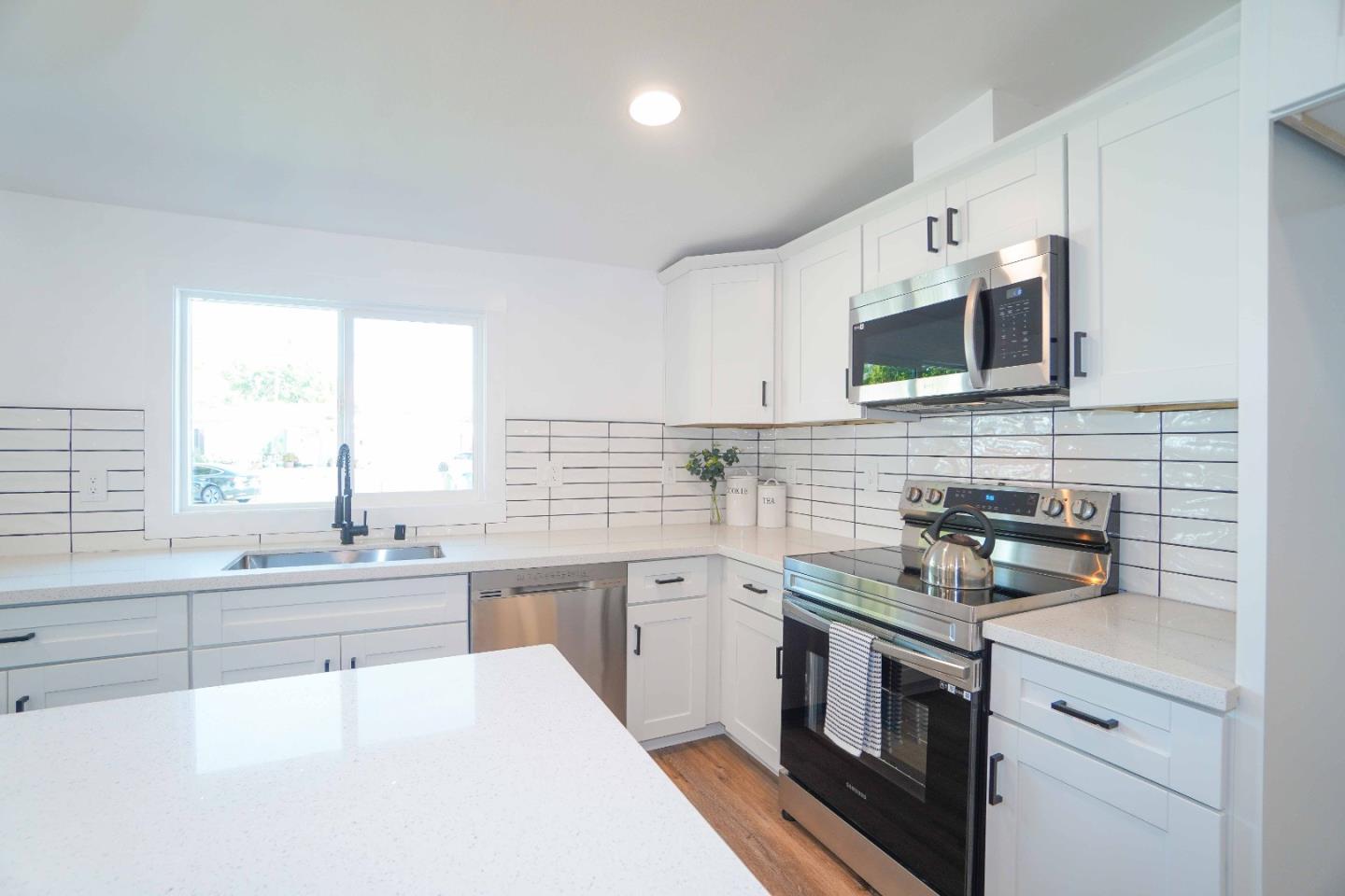 75 Lawton Drive Milpitas, CA 95035 - Photo 14 of 32 a kitchen with a sink stove and microwave