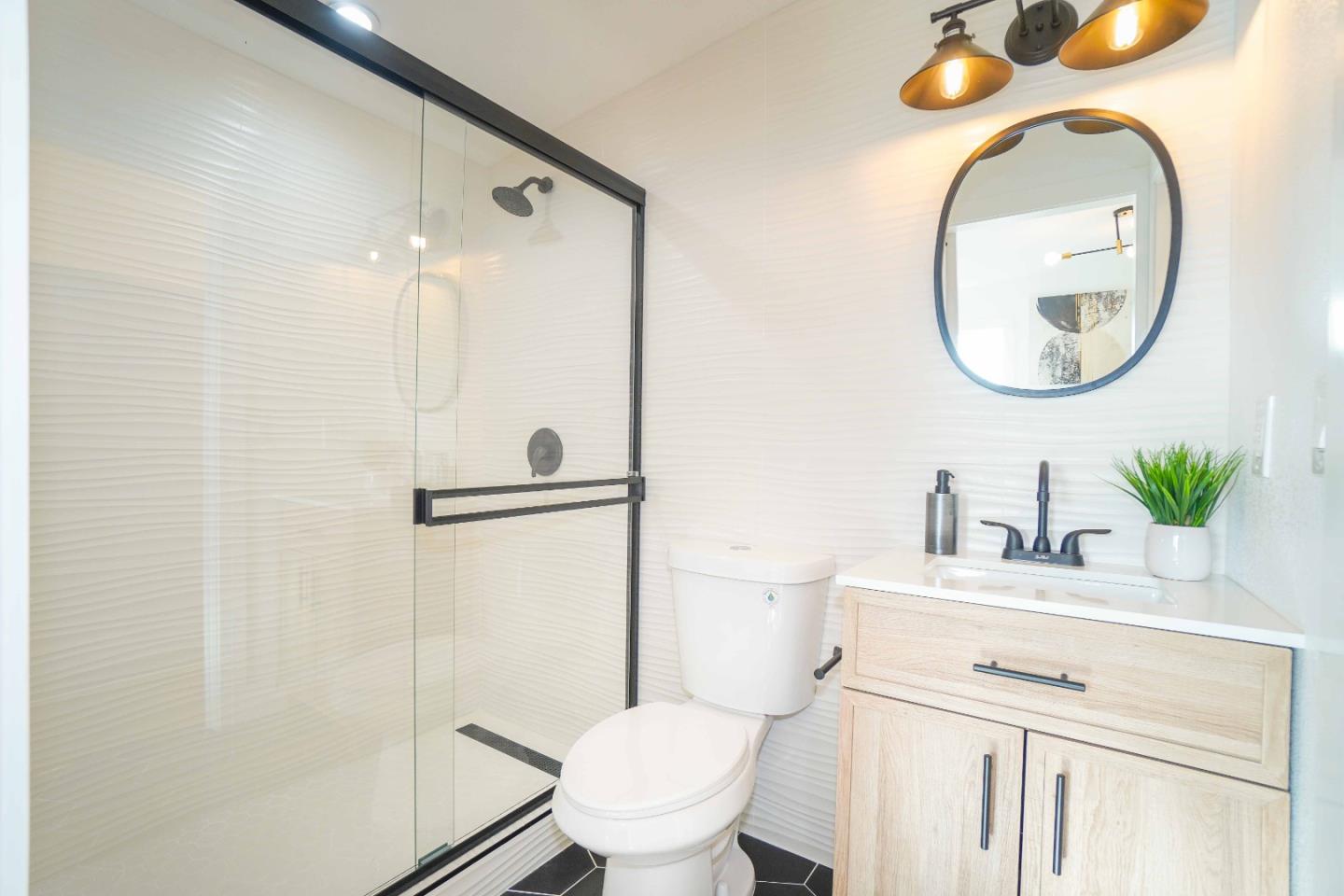 75 Lawton Drive Milpitas, CA 95035 - Photo 17 of 32 a bathroom with a sink a toilet and a mirror