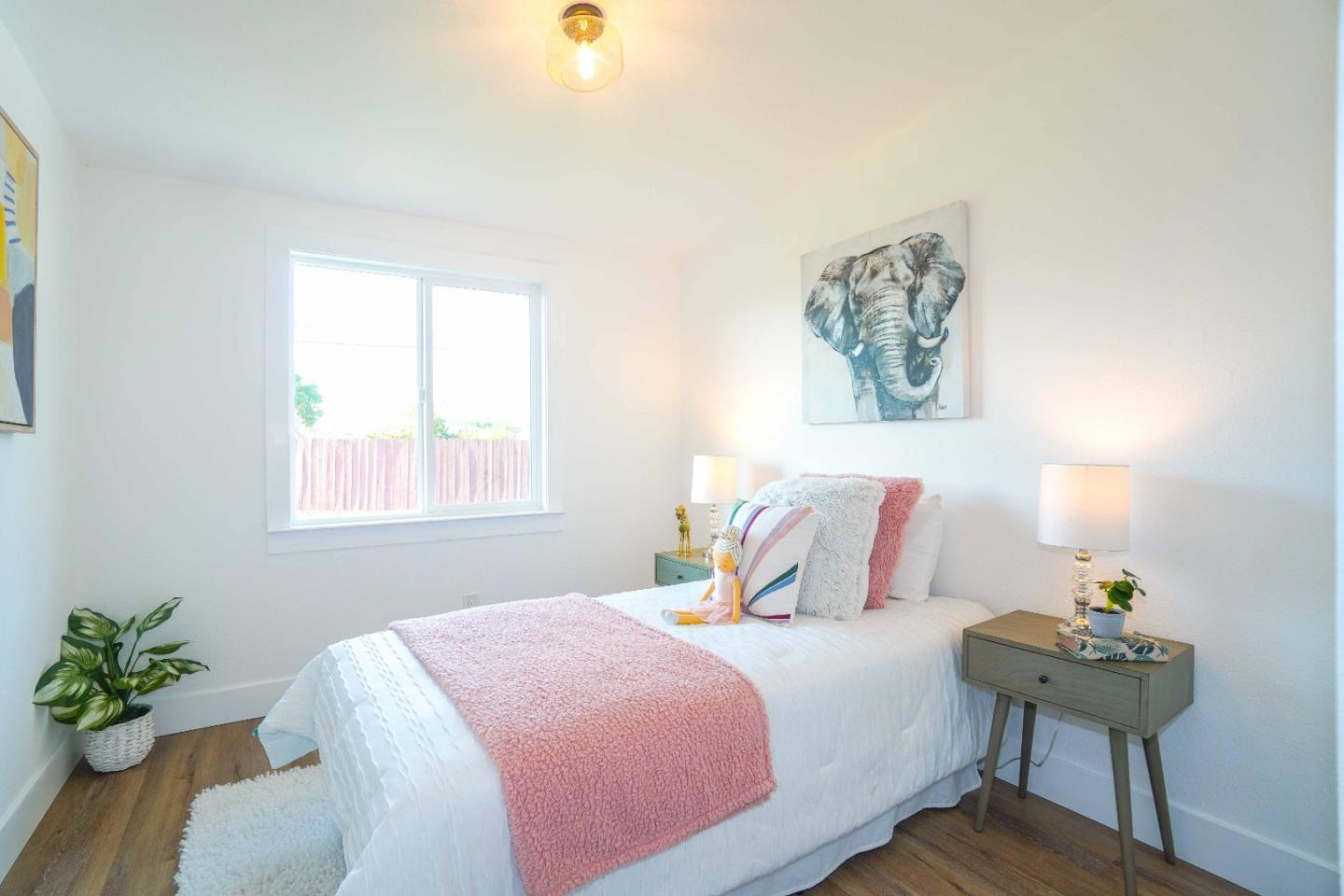 75 Lawton Drive Milpitas, CA 95035 - Photo 20 of 32 a bedroom with a bed and a potted plant