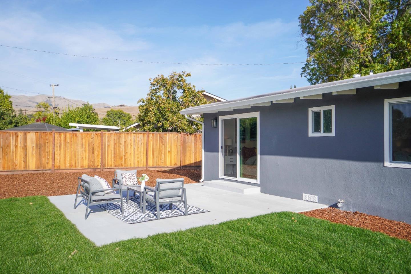 75 Lawton Drive Milpitas, CA 95035 - Photo 29 of 32 a view of a patio with table and chairs with wooden floor and fence