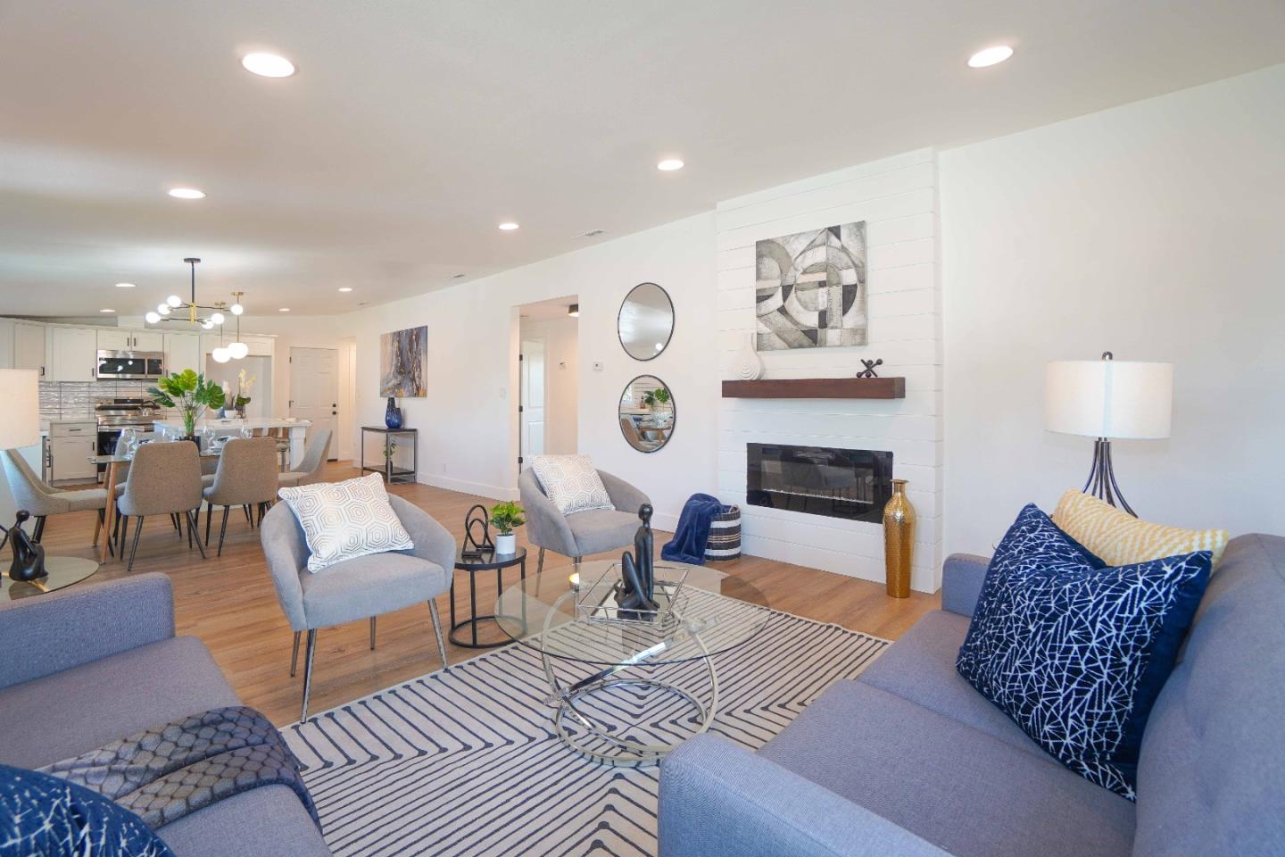 75 Lawton Drive Milpitas, CA 95035 - Photo 7 of 32 a living room with furniture a fireplace and a flat screen tv