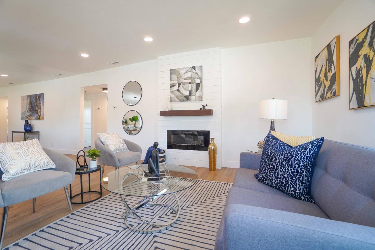 75 Lawton Drive Milpitas, CA 95035 - Photo 8 of 32 a living room with furniture a clock and a fireplace