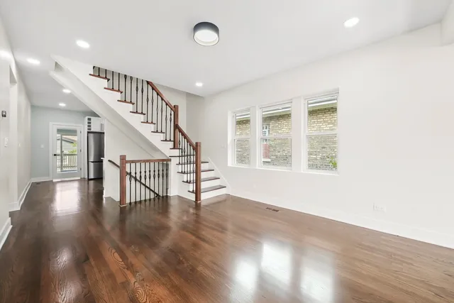 a view of an entryway with wooden floor