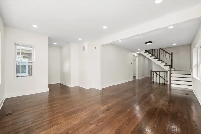 a view of entryway and hall with wooden floor