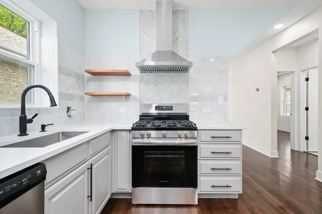 a kitchen with granite countertop a stove and a sink